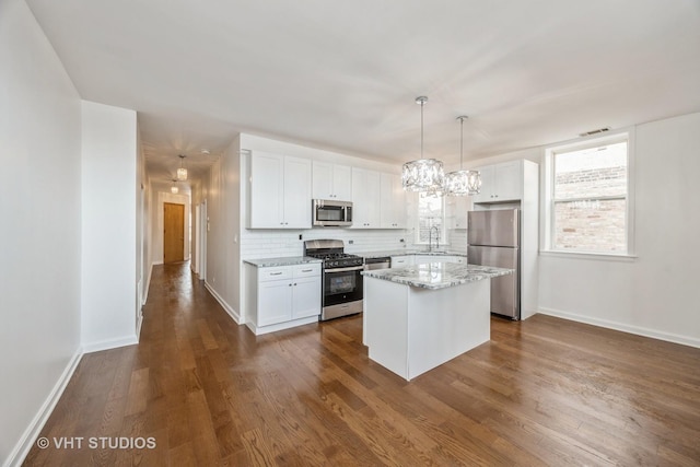 745 S Independence Blvd Unit 3N, Chicago, IL 60624 - kitchen featuring stainless steel appliances, white cabinets, a chandelier, and dark wood-style floors