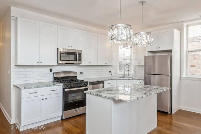 745 S Independence Blvd Unit 3N, Chicago, IL 60624 - kitchen with stainless steel appliances, healthy amount of natural light, decorative backsplash, and white cabinets