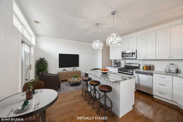 745 S Independence Blvd Unit 3N, Chicago, IL 60624 - kitchen featuring stainless steel appliances, a center island, tasteful backsplash, and white cabinets