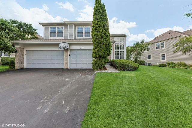 2397 Pebble Beach Ln, Riverwoods, IL 60015 - view of front of house with driveway, an attached garage, a front yard, and brick siding