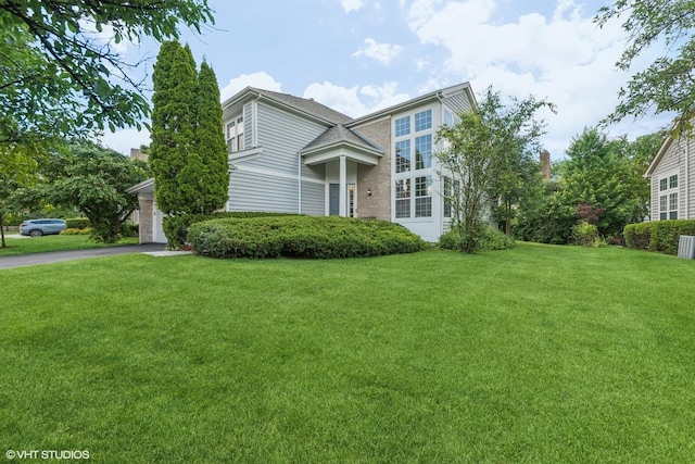 2397 Pebble Beach Ln, Riverwoods, IL 60015 - view of front facade featuring a front lawn, asphalt driveway, and a garage