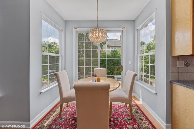 2397 Pebble Beach Ln, Riverwoods, IL 60015 - dining room featuring healthy amount of natural light, a chandelier, and wood finished floors