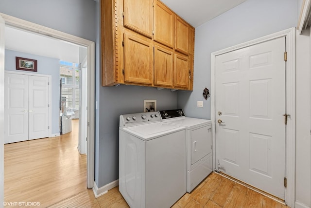 2397 Pebble Beach Ln, Riverwoods, IL 60015 - laundry room with light wood-style flooring, washing machine and clothes dryer, and cabinet space