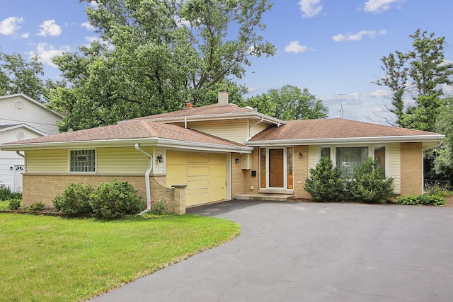 17W455 Concord Pl, Darien, IL 60561 - tri-level home with brick siding, a garage, a front lawn, asphalt driveway, and a chimney