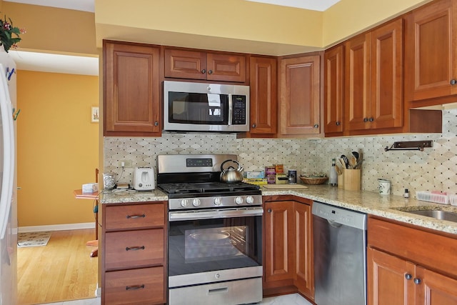 17W455 Concord Pl, Darien, IL 60561 - kitchen with stainless steel appliances, brown cabinetry, and tasteful backsplash