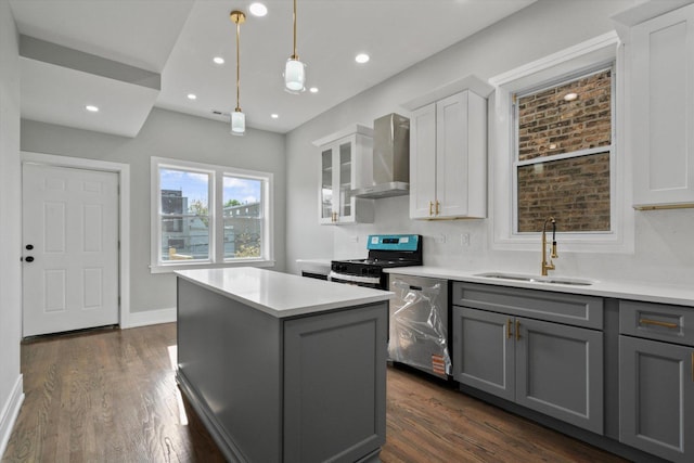 1521 N Maplewood Ave, Chicago, IL 60622 - kitchen featuring wall chimney exhaust hood, stainless steel appliances, gray cabinets, a center island, and dark wood-style floors