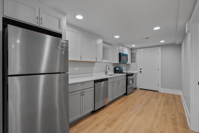 1521 N Maplewood Ave, Chicago, IL 60622 - kitchen featuring appliances with stainless steel finishes, light countertops, light wood-type flooring, gray cabinetry, and recessed lighting
