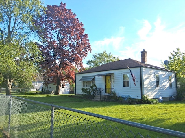 bungalow-style home featuring a chimney and a fenced backyard