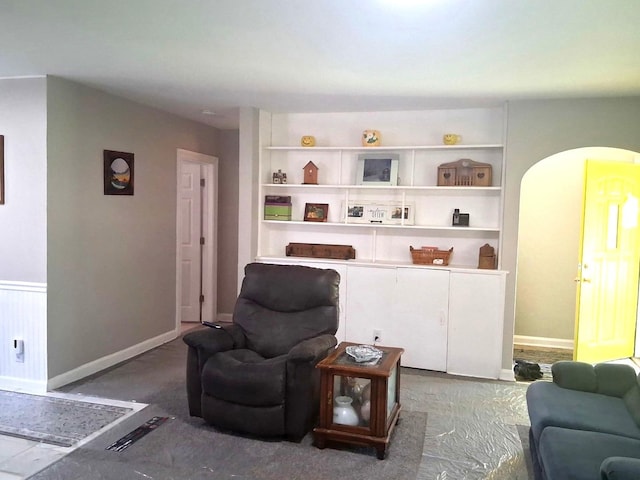 living room featuring built in features and baseboards