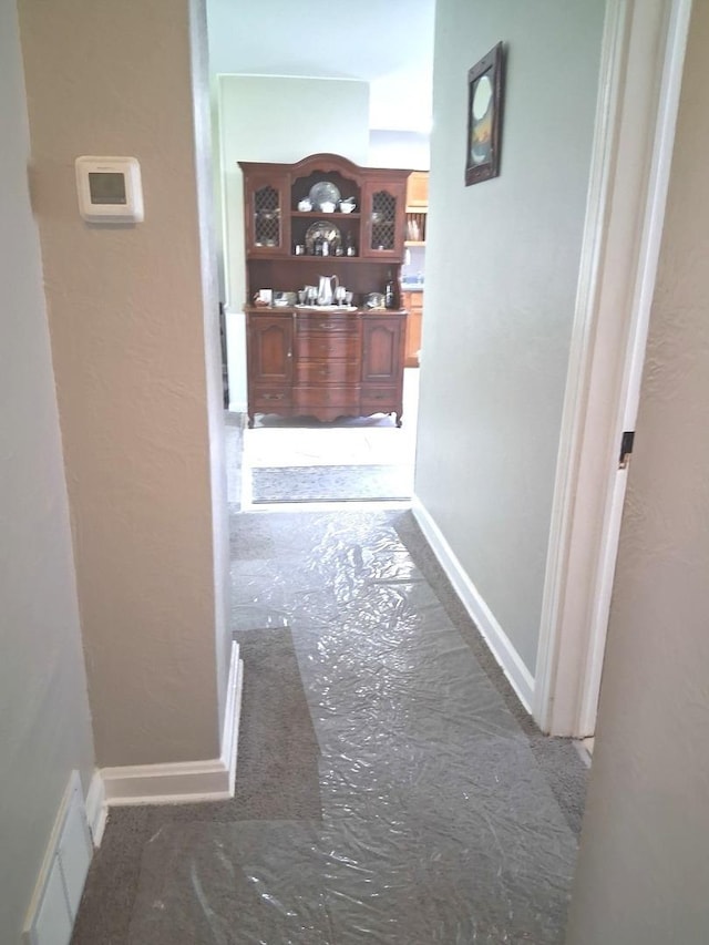 corridor featuring baseboards