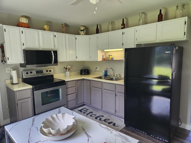 90 W George Ave, Cortland, IL 60112 - kitchen featuring stainless steel appliances, light countertops, open shelves, a ceiling fan, and white cabinetry