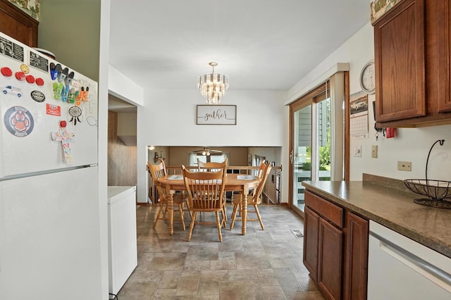 510 Dunbar St, Beecher, IL 60401 - dining space featuring stone finish floors, washer / dryer, and a chandelier