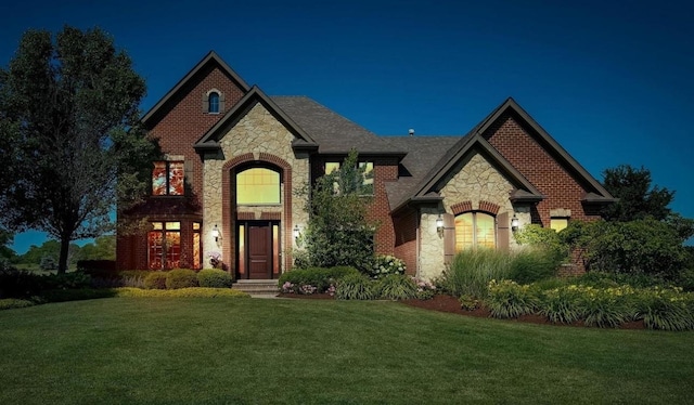 4213 Steam Mill Ct, Oswego, IL 60543 - french country style house featuring stone siding, a front yard, and brick siding