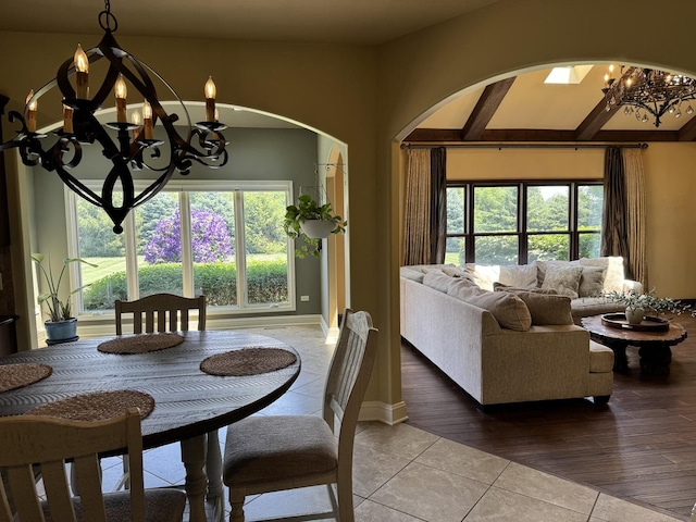 4213 Steam Mill Ct, Oswego, IL 60543 - tiled dining area with a chandelier, arched walkways, and healthy amount of natural light