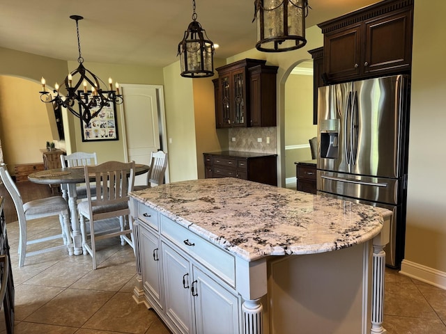 4213 Steam Mill Ct, Oswego, IL 60543 - kitchen featuring stainless steel fridge with ice dispenser, arched walkways, a chandelier, dark brown cabinets, and backsplash