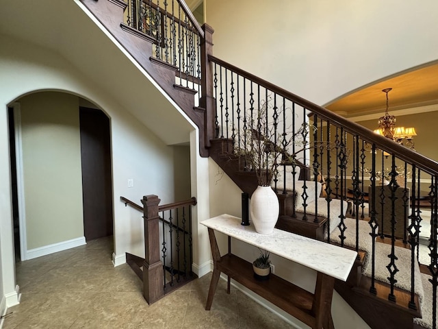 4213 Steam Mill Ct, Oswego, IL 60543 - staircase featuring arched walkways, a chandelier, and crown molding