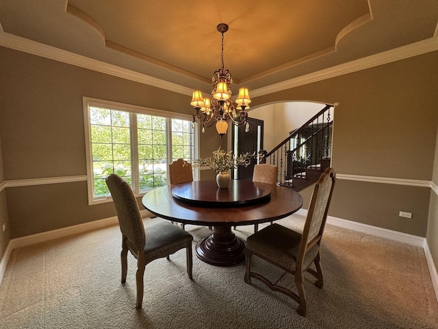 4213 Steam Mill Ct, Oswego, IL 60543 - carpeted dining room with a chandelier, a raised ceiling, arched walkways, stairway, and crown molding