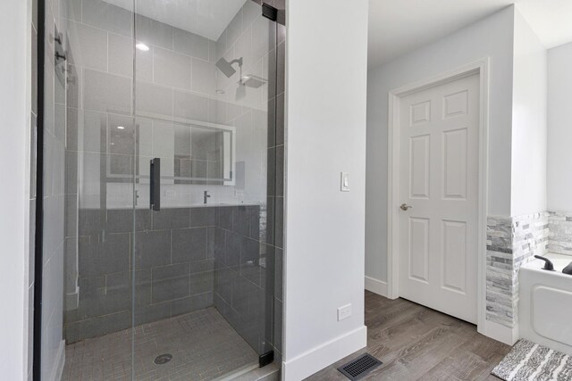 2751 Cedar Creek Cutoff Rd, Wauconda, IL 60084 - bathroom with a bath, a stall shower, and wood finished floors