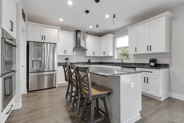2751 Cedar Creek Cutoff Rd, Wauconda, IL 60084 - kitchen with appliances with stainless steel finishes, wall chimney range hood, tasteful backsplash, light wood-style flooring, and recessed lighting