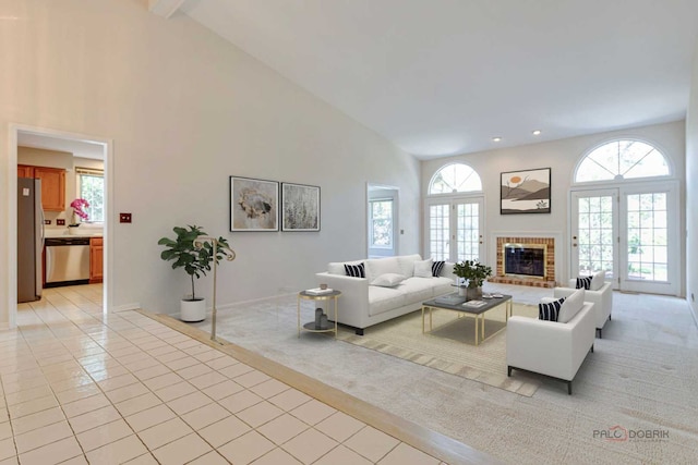 122 Kilchurn Ln, Inverness, IL 60067 - living room with high vaulted ceiling, healthy amount of natural light, light tile patterned floors, a fireplace, and light carpet