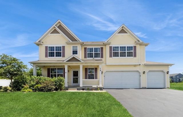 15 Richmond Cir S, Elgin, IL 60177 - view of front of home with driveway, a front yard, a garage, and covered porch