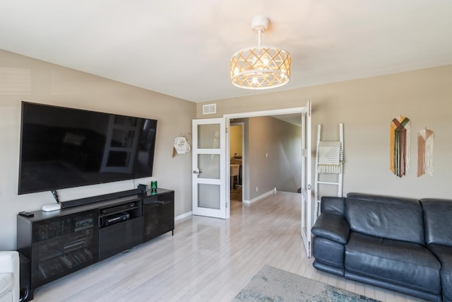 15 Richmond Cir S, Elgin, IL 60177 - living area featuring light wood-style flooring, a chandelier, and french doors