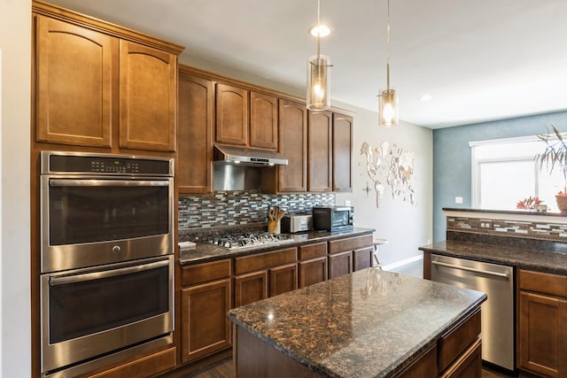 15 Richmond Cir S, Elgin, IL 60177 - kitchen featuring appliances with stainless steel finishes, tasteful backsplash, a kitchen island, under cabinet range hood, and recessed lighting