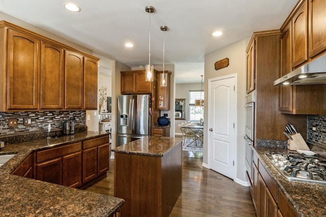 15 Richmond Cir S, Elgin, IL 60177 - kitchen featuring appliances with stainless steel finishes, decorative backsplash, dark wood-style floors, decorative light fixtures, and under cabinet range hood
