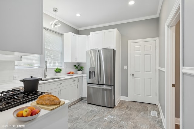 642 E 90th St, Chicago, IL 60619 - kitchen featuring stainless steel refrigerator with ice dispenser, white cabinetry, light countertops, ornamental molding, and tasteful backsplash