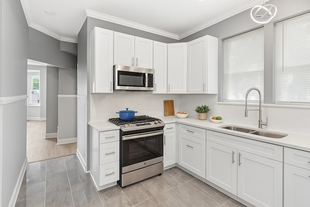 642 E 90th St, Chicago, IL 60619 - kitchen with appliances with stainless steel finishes, light countertops, tasteful backsplash, and crown molding