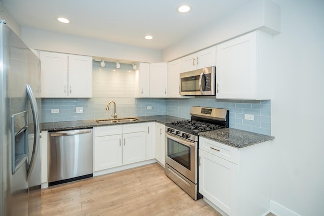 4833 W 109th St Unit 103, Oak Lawn, IL 60453 - kitchen featuring appliances with stainless steel finishes, white cabinetry, dark stone counters, light wood-style flooring, and recessed lighting