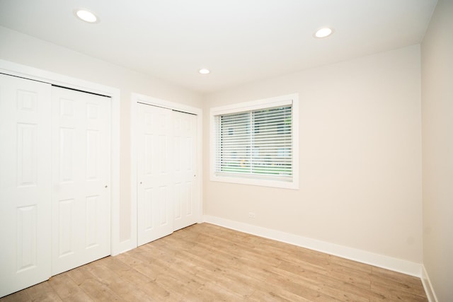4833 W 109th St Unit 103, Oak Lawn, IL 60453 - unfurnished bedroom featuring two closets, light wood-type flooring, and recessed lighting