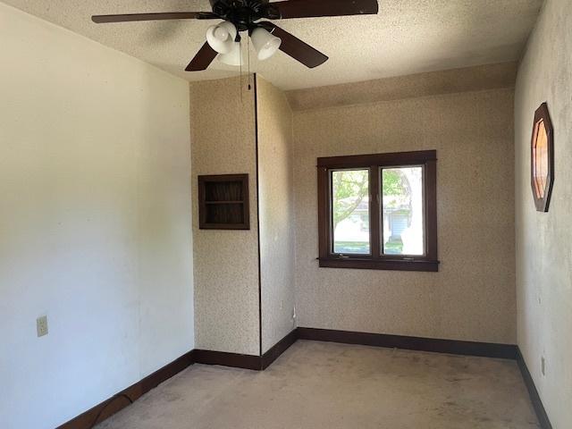 1322 N Prairie Ave, Joliet, IL 60435 - unfurnished room featuring light carpet, ceiling fan, and a textured ceiling
