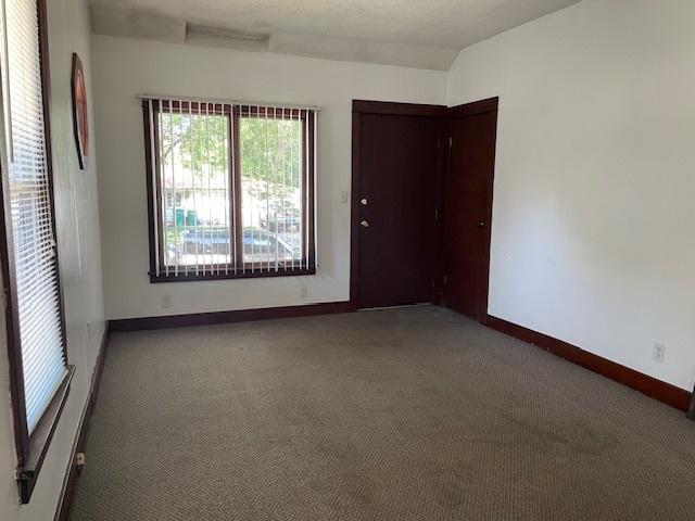 1322 N Prairie Ave, Joliet, IL 60435 - carpeted empty room with baseboards