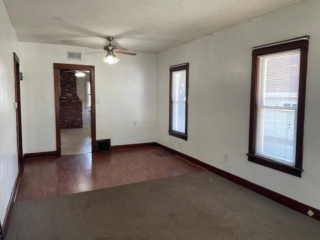 1322 N Prairie Ave, Joliet, IL 60435 - carpeted spare room featuring ceiling fan, healthy amount of natural light, a textured ceiling, and wood finished floors