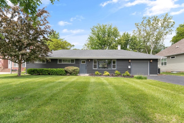 705 Parkway Dr, Wheaton, IL 60187 - ranch-style house featuring a garage, driveway, a front lawn, and a chimney