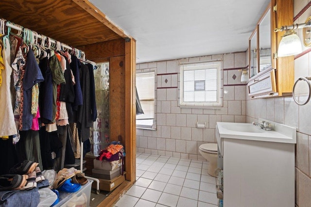 1619 S 61st Ave, Cicero, IL 60804 - bathroom featuring tile patterned flooring, vanity, a shower, and tile walls