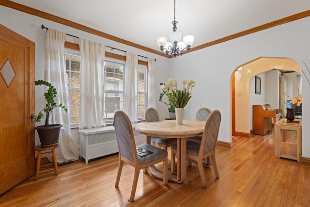 1619 S 61st Ave, Cicero, IL 60804 - dining space featuring a chandelier, arched walkways, light wood finished floors, radiator, and ornamental molding