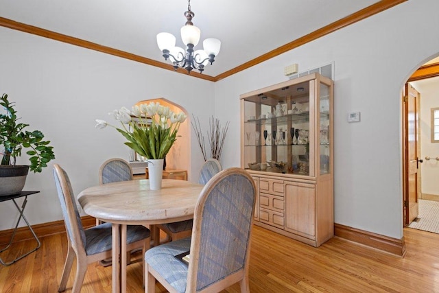 1619 S 61st Ave, Cicero, IL 60804 - dining space with arched walkways, a chandelier, light wood-style floors, and ornamental molding