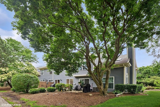 1039 Talbots Ln, Elk Grove Village, IL 60007 - rear view of property featuring a chimney and a yard