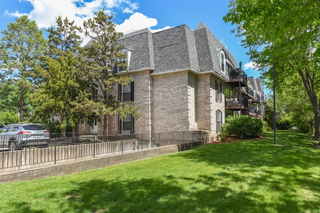5400 Carriageway Dr Unit 315, Rolling Meadows, IL 60008 - view of property exterior with mansard roof, brick siding, and roof with shingles