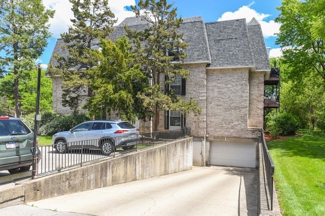 5400 Carriageway Dr Unit 315, Rolling Meadows, IL 60008 - view of front facade featuring brick siding, an attached garage, a shingled roof, and concrete driveway