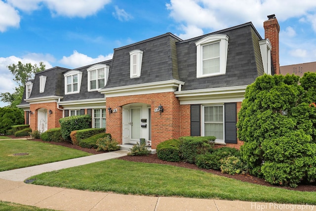 336 Eastern Ave, Barrington, IL 60010 - view of front facade with mansard roof, roof with shingles, brick siding, and a front yard