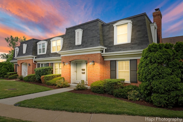 336 Eastern Ave, Barrington, IL 60010 - view of front of house with mansard roof, a shingled roof, brick siding, and a front yard