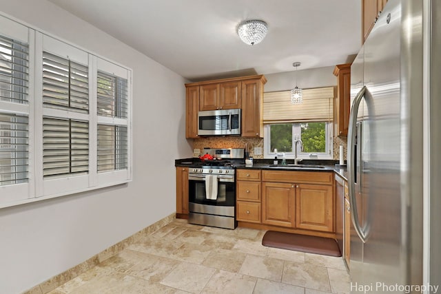 336 Eastern Ave, Barrington, IL 60010 - kitchen featuring appliances with stainless steel finishes, tasteful backsplash, dark countertops, stone tile flooring, and brown cabinets