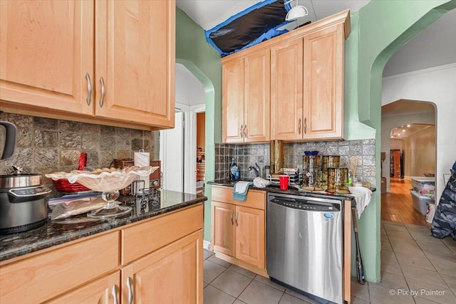 6121 N Hoyne Ave Unit 1S, Chicago, IL 60659 - kitchen featuring stainless steel dishwasher, arched walkways, light brown cabinets, light tile patterned floors, and dark stone countertops