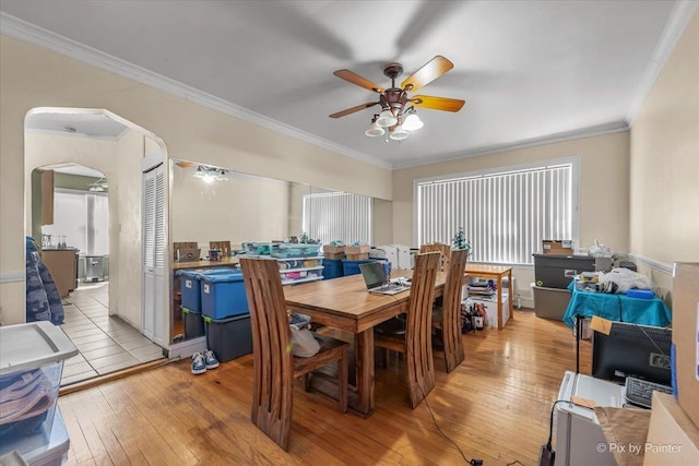 6121 N Hoyne Ave Unit 1S, Chicago, IL 60659 - dining space with ceiling fan, light wood-type flooring, crown molding, and arched walkways