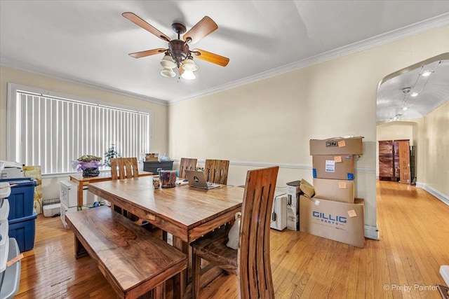 6121 N Hoyne Ave Unit 1S, Chicago, IL 60659 - dining room with arched walkways, a ceiling fan, light wood finished floors, and crown molding