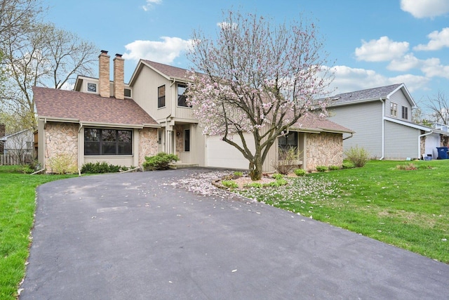 397 Briarwood Ct, Gurnee, IL 60031 - view of front facade with stone siding, a chimney, driveway, and a front yard