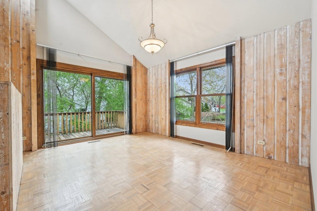 397 Briarwood Ct, Gurnee, IL 60031 - spare room with plenty of natural light, high vaulted ceiling, and wooden walls